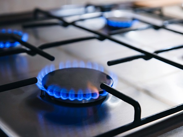gas hob switched on with blue flame